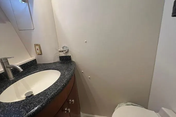 Kiki's Tiki Yacht Photos Pics Bathroom interior of 2000 Carver 506 Motor Yacht with sink and toilet.