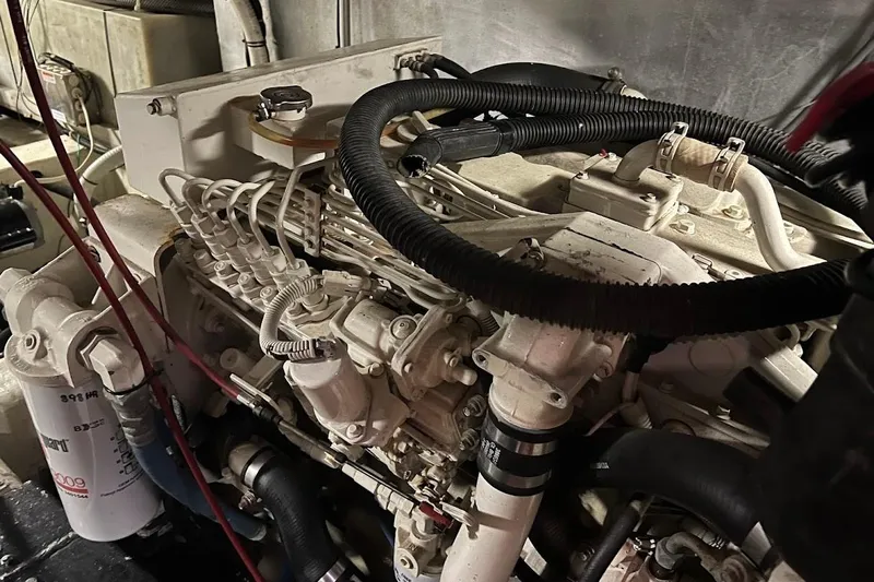 Kiki's Tiki Yacht Photos Pics Engine room of a 2000 Carver 506 Motor Yacht, showcasing mechanical components and hoses.