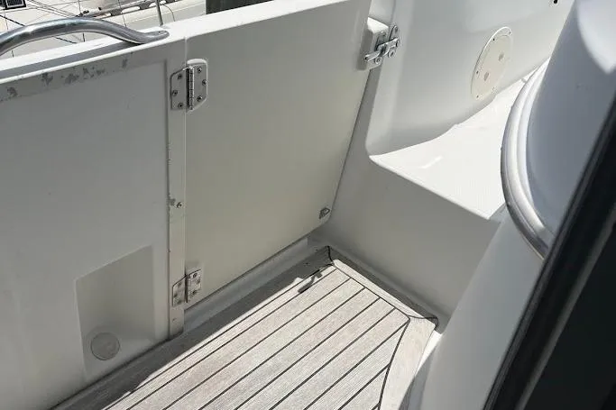 Kiki's Tiki Yacht Photos Pics Carver 506 Motor Yacht 2000, deck area with wooden flooring and white railing.