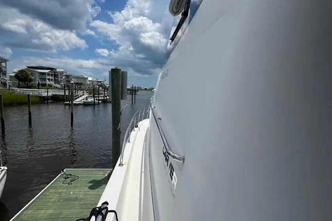Kiki's Tiki Yacht Photos Pics 2000 Carver 506 Motor Yacht docked at marina under cloudy sky.