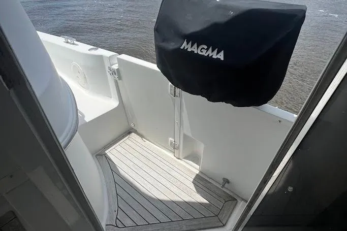 Kiki's Tiki Yacht Photos Pics Carver 506 Motor Yacht 2000 deck with Magma grill cover, overlooking water.