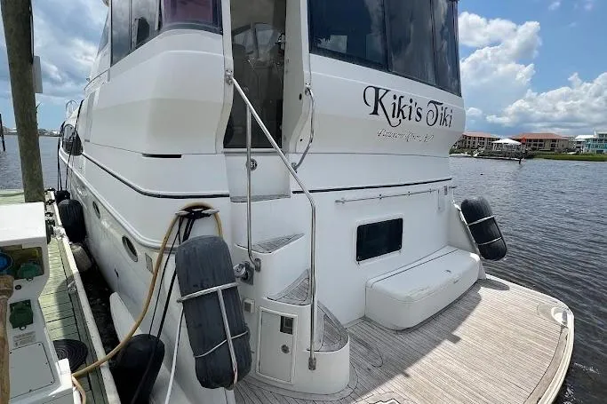 Kiki's Tiki Yacht Photos Pics 2000 Carver 506 Motor Yacht docked, featuring "Kiki's Tiki" name on the stern.