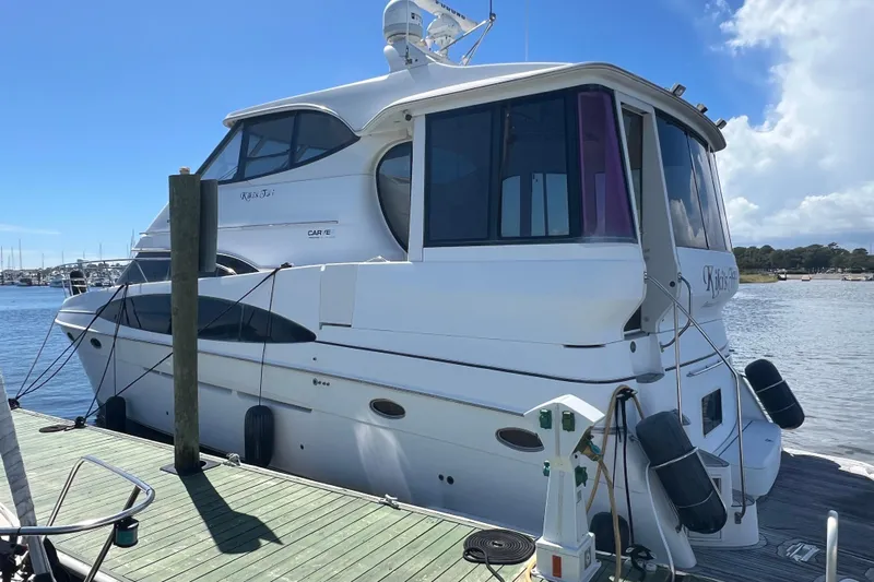 Kiki's Tiki Yacht Photos Pics 2000 Carver 506 Motor Yacht docked at marina under clear blue sky.
