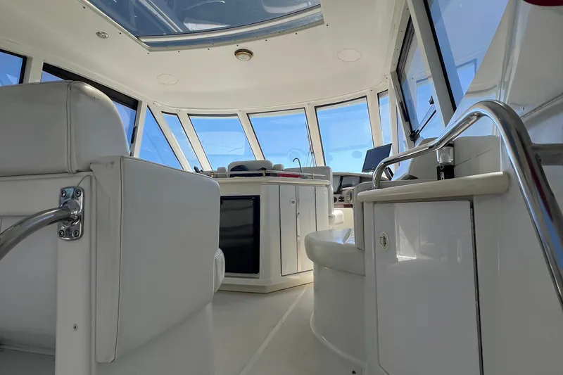 Kiki's Tiki Yacht Photos Pics Interior of 2000 Carver 506 Motor Yacht with white seating and panoramic windows.