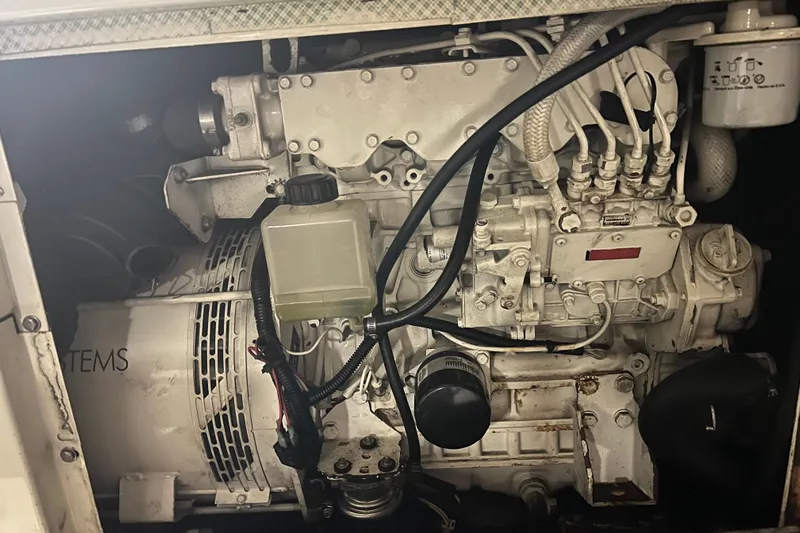 Kiki's Tiki Yacht Photos Pics Engine compartment of a 2000 Carver 506 Motor Yacht, showcasing mechanical components and wiring.