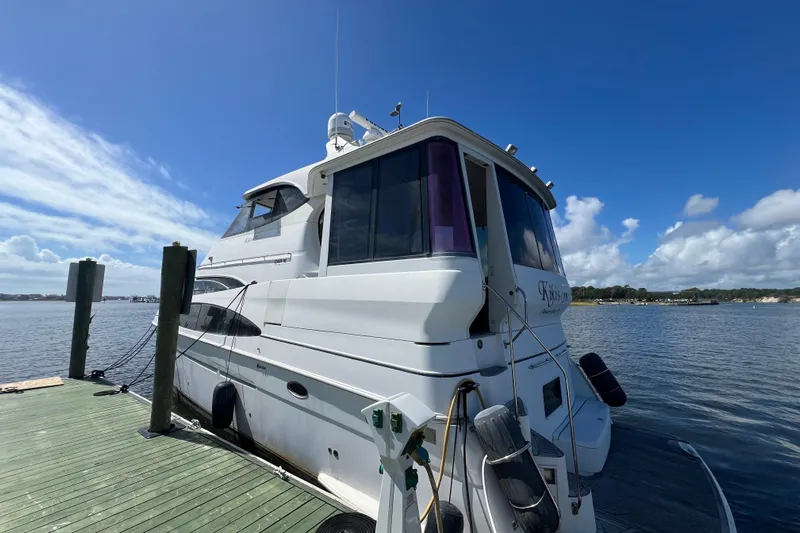 Kiki's Tiki Yacht Photos Pics 2000 Carver 506 Motor Yacht docked on a sunny day with blue skies.