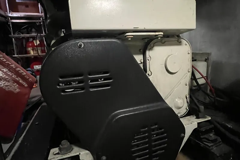 Kiki's Tiki Yacht Photos Pics Engine compartment of a 2000 Carver 506 Motor Yacht, featuring mechanical components and wiring.