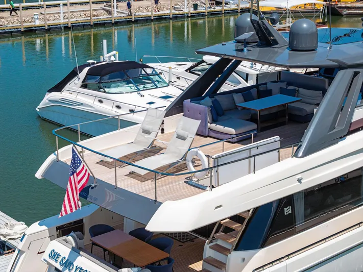 She Said Yes! Again Yacht Photos Pics 2018 Ferretti Yachts 780 docked, featuring spacious deck with seating and American flag.