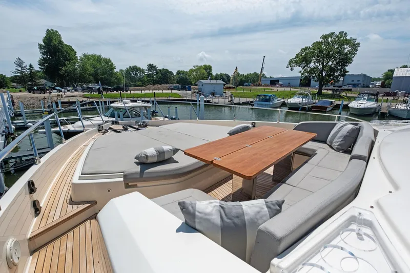 She Said Yes! Again Yacht Photos Pics Luxurious 2018 Ferretti Yachts 780 with spacious deck seating and wooden table, docked at marina.