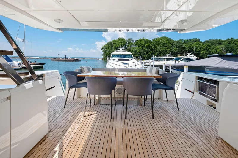 She Said Yes! Again Yacht Photos Pics Luxurious 2018 Ferretti Yachts 780 deck with elegant dining area, overlooking serene marina.