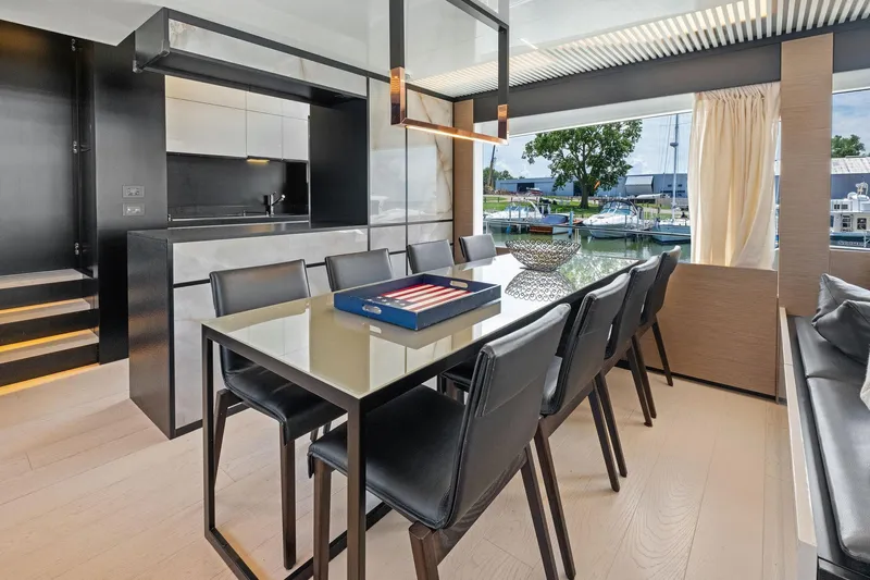 She Said Yes! Again Yacht Photos Pics Luxurious dining area on a 2018 Ferretti Yachts 780, featuring modern decor and marina view.