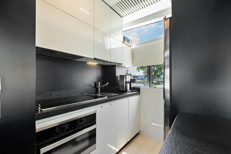 She Said Yes! Again Yacht Photos Pics Modern kitchen interior on 2018 Ferretti Yachts 780, featuring sleek cabinetry and appliances.