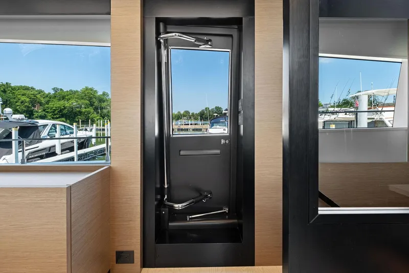 She Said Yes! Again Yacht Photos Pics Interior view of 2018 Ferretti Yachts 780, showcasing sleek modern design and marina backdrop.