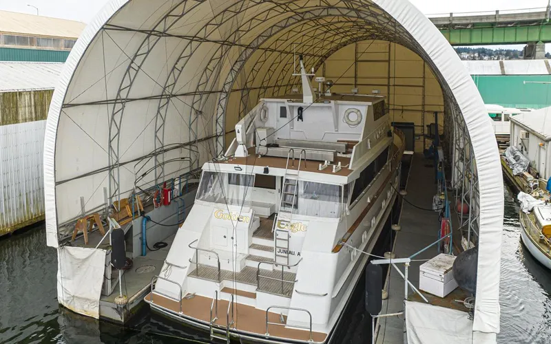 Eagles Nest Yacht Photos Pics Custom 2005 boathouse with yacht in dry dock, sheltered by a large canopy.
