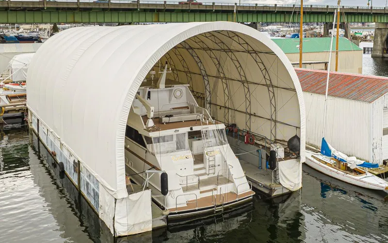 Eagles Nest Yacht Photos Pics Custom boathouse dry dock with yacht, 2005 model, sheltered under a large canopy.
