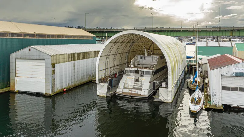 Eagles Nest Yacht Photos Pics Custom 2005 boathouse with yacht in dry dock, surrounded by water and industrial buildings.