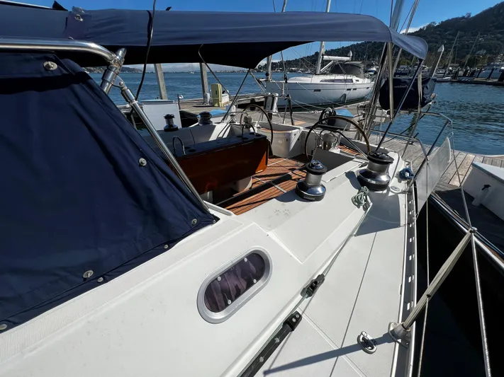 Between The Sheets Yacht Photos Pics Jeanneau 52.2 sailboat, 2000 model, docked with blue canopy and visible deck equipment.