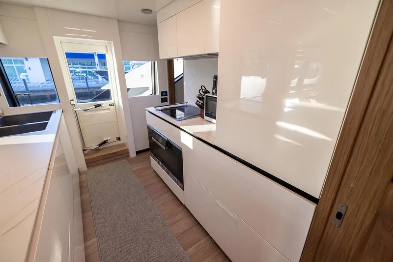 Life: For Sale Yacht Photos Pics Modern kitchen interior of 2021 Ferretti Yachts 920 with sleek design and appliances.