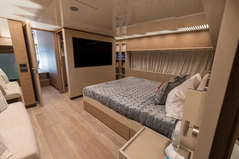 Life: For Sale Yacht Photos Pics Luxurious bedroom interior of 2021 Ferretti Yachts 920 with modern design and cozy bedding.