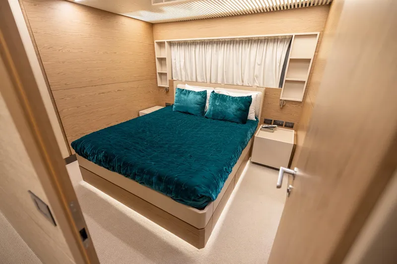Life: For Sale Yacht Photos Pics Luxurious bedroom interior on 2021 Ferretti Yachts 920, featuring elegant teal bedding.