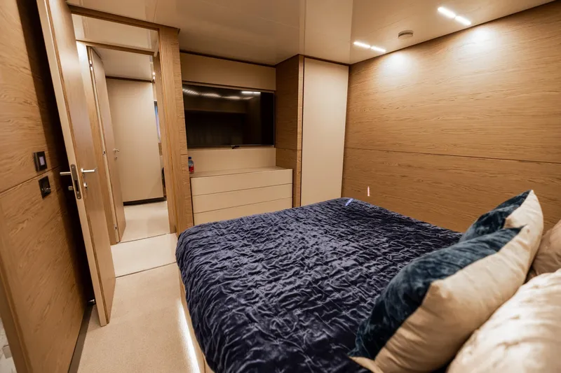 Life: For Sale Yacht Photos Pics Luxurious bedroom interior of 2021 Ferretti Yachts 920 with modern wood paneling.