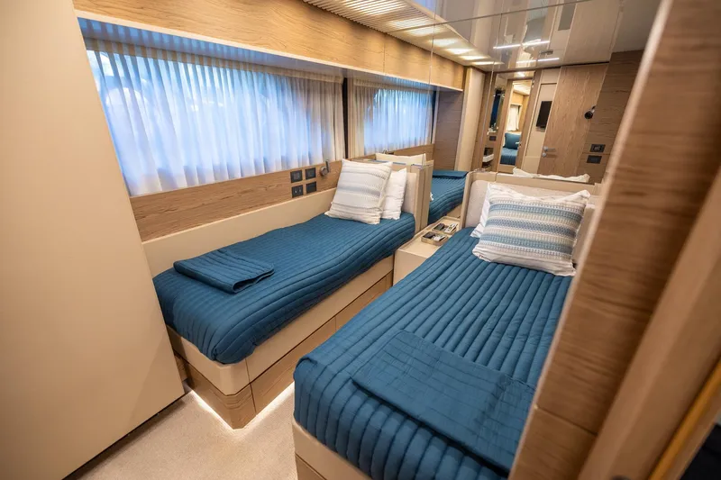 Life: For Sale Yacht Photos Pics Luxurious twin cabin interior on 2021 Ferretti Yachts 920 with blue bedding.