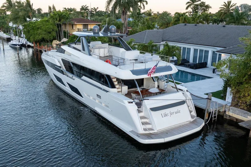 Life: For Sale Yacht Photos Pics 2021 Ferretti Yachts 920 docked by a luxurious waterfront home.