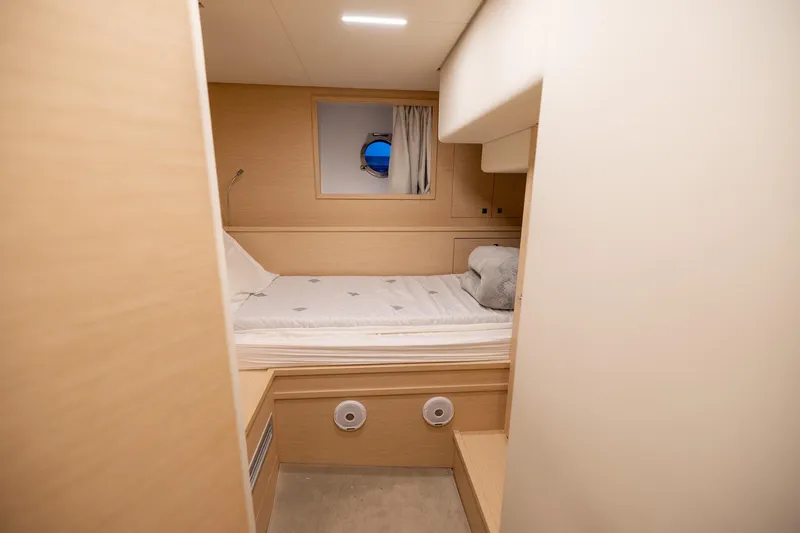 Life: For Sale Yacht Photos Pics Luxurious cabin interior of 2021 Ferretti Yachts 920 with cozy bed and porthole view.