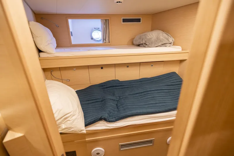 Life: For Sale Yacht Photos Pics Cozy cabin with bunk beds in 2021 Ferretti Yachts 920, featuring light wood interior.