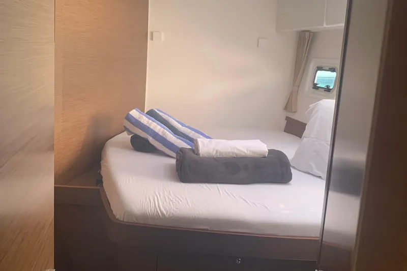 Oceanfront Yacht Photos Pics Cozy cabin interior of 2019 Lagoon 42 yacht with neatly arranged bedding.