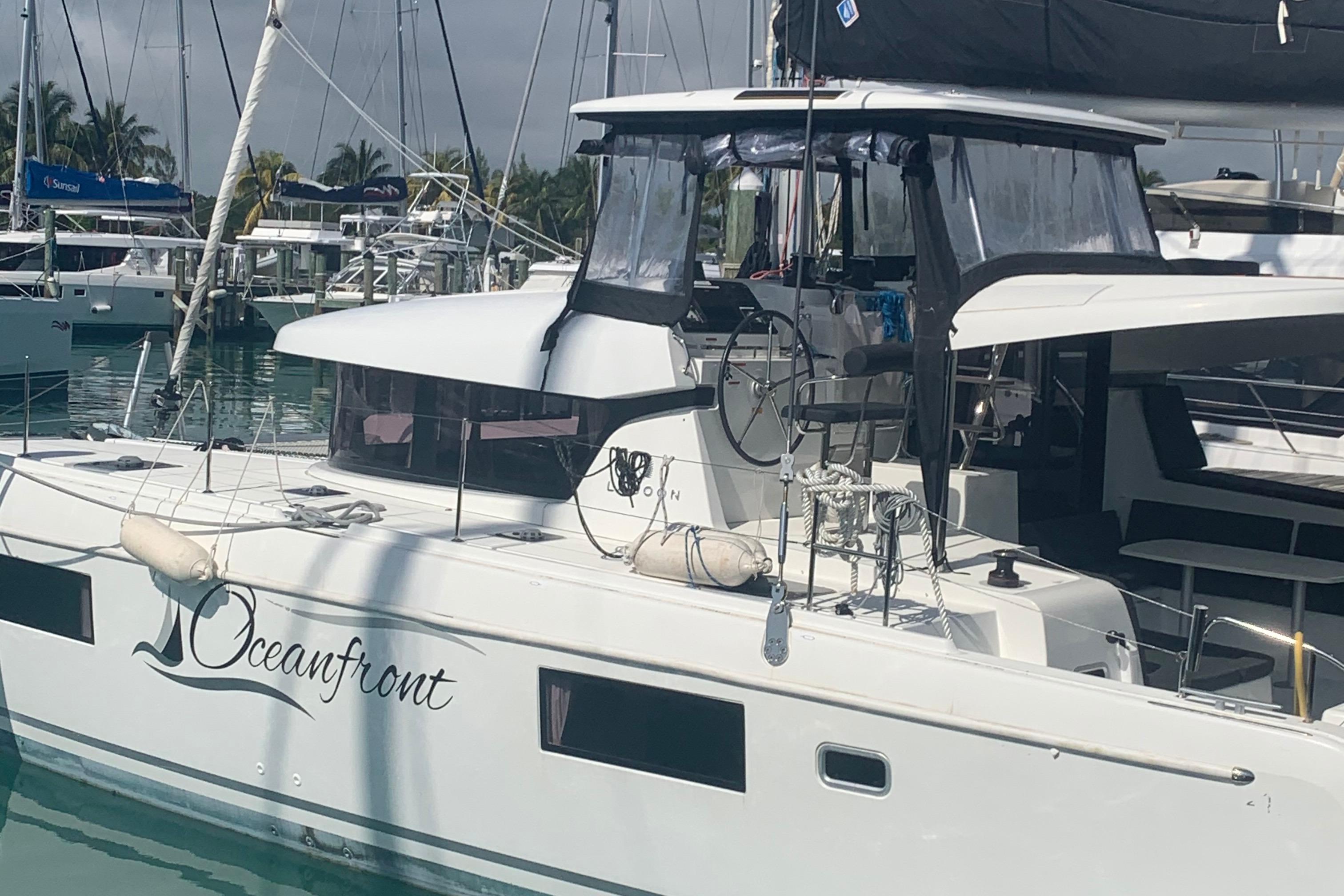 2019 Lagoon 42 catamaran named "Oceanfront" docked at a marina.