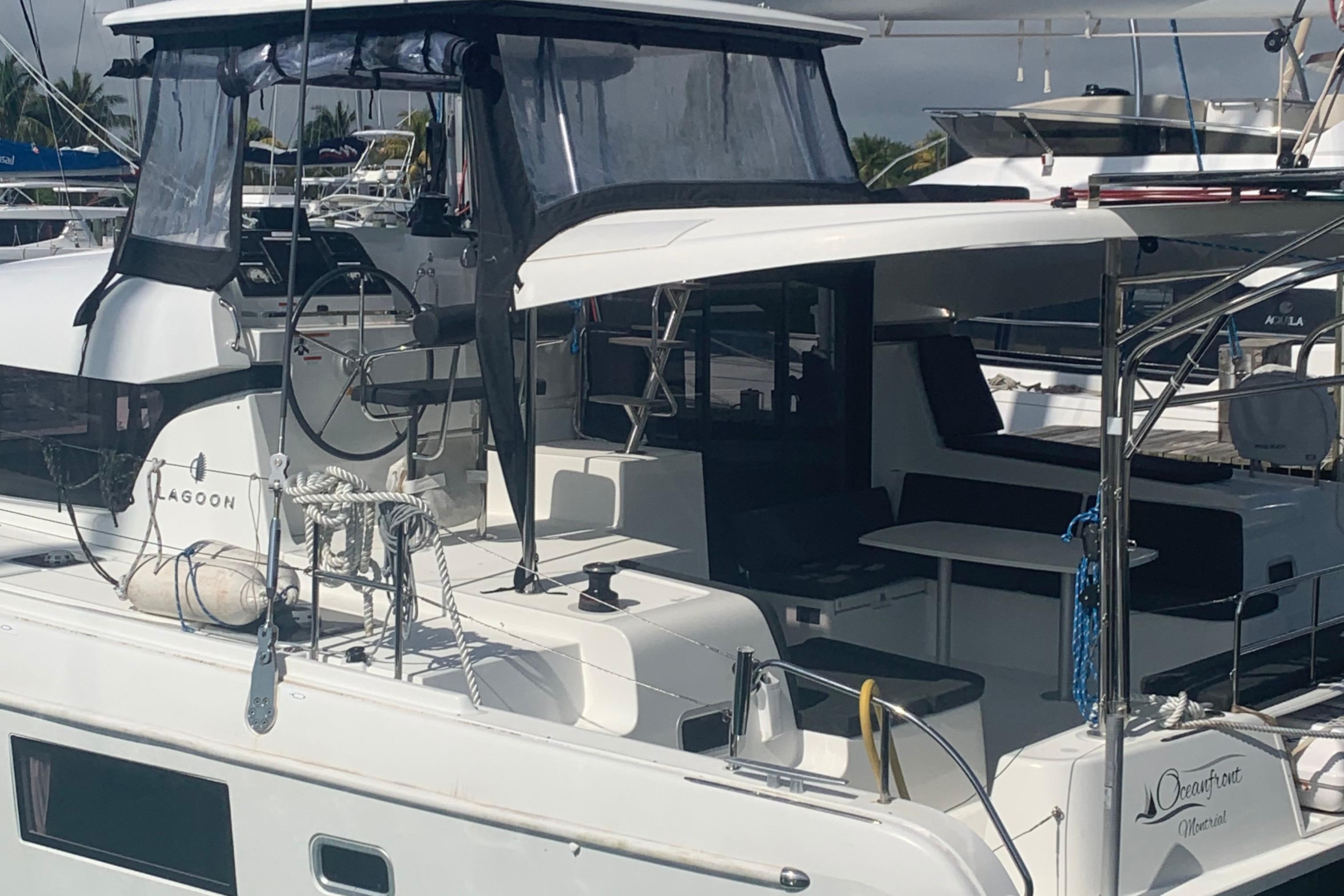 2019 Lagoon 42 catamaran docked, featuring spacious deck and modern design.