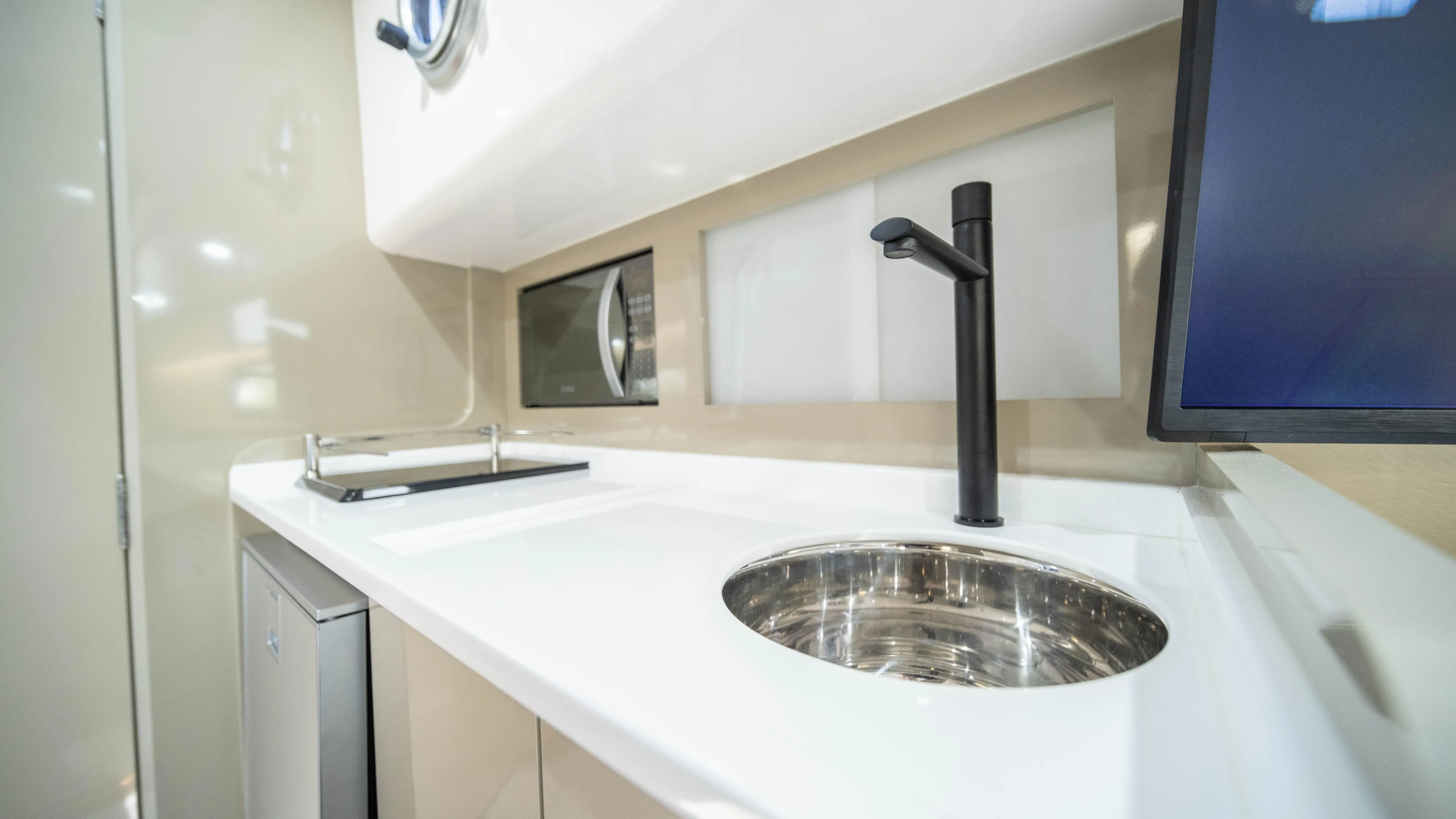 Custom Order Yours Today! Yacht Photos Pics Modern kitchen area in 2025 Hanover 387 Outboard boat with sleek sink and appliances.