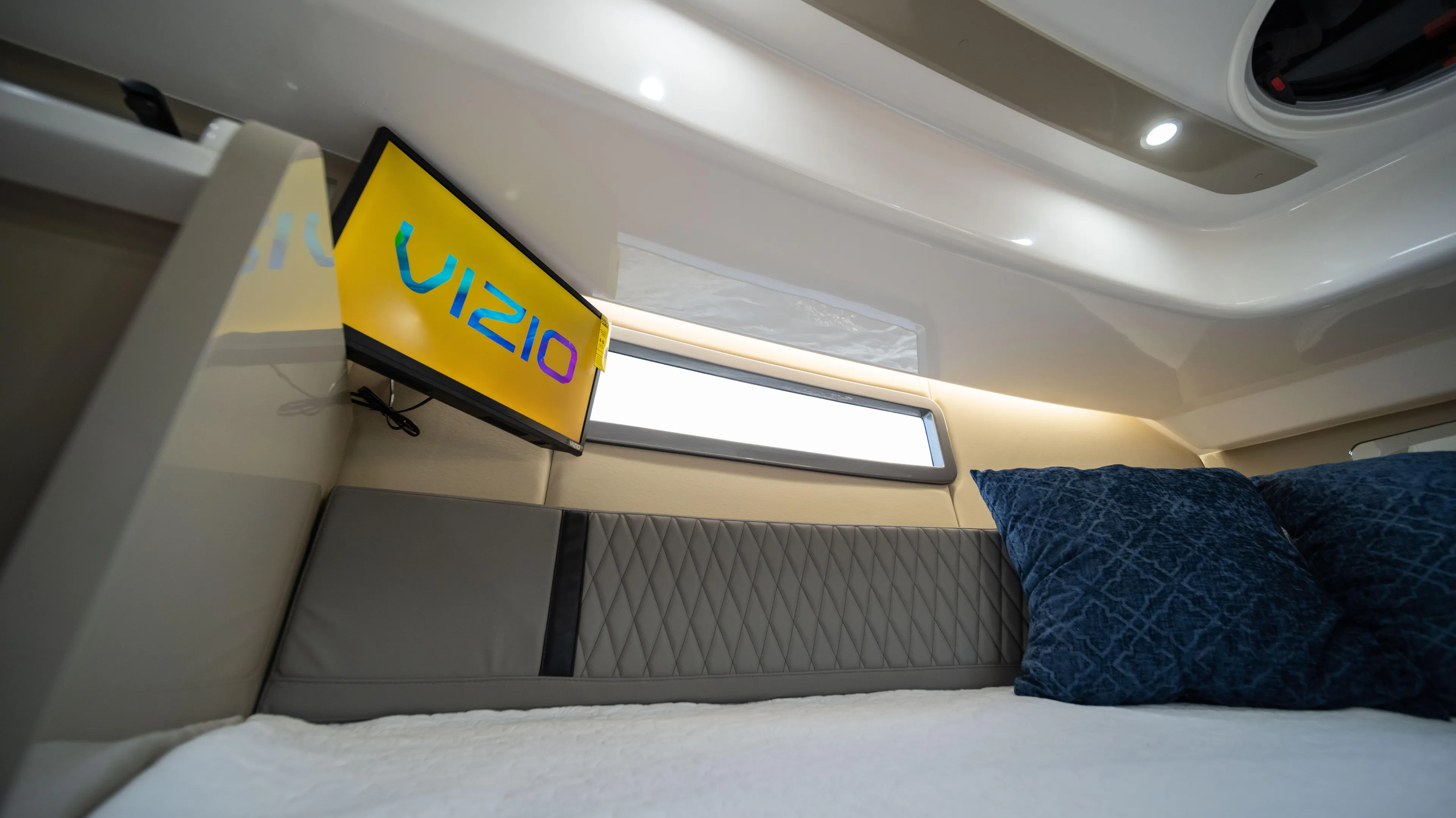 Custom Order Yours Today! Yacht Photos Pics 2025 Hanover 387 Outboard cabin interior with Vizio TV and blue pillows.