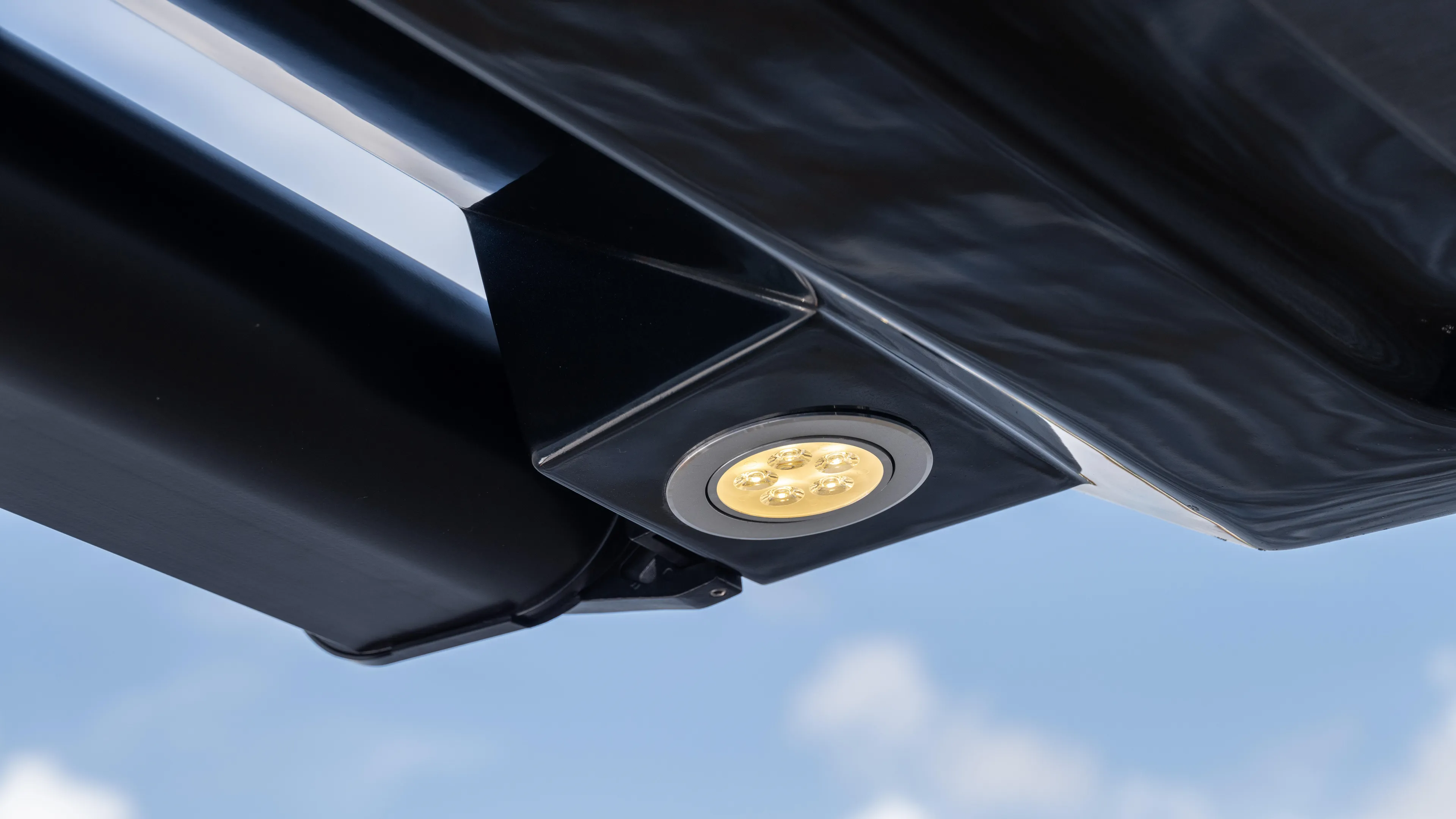 Custom Order Yours Today! Yacht Photos Pics Close-up of Hanover 387 Outboard 2025 LED light fixture against blue sky.