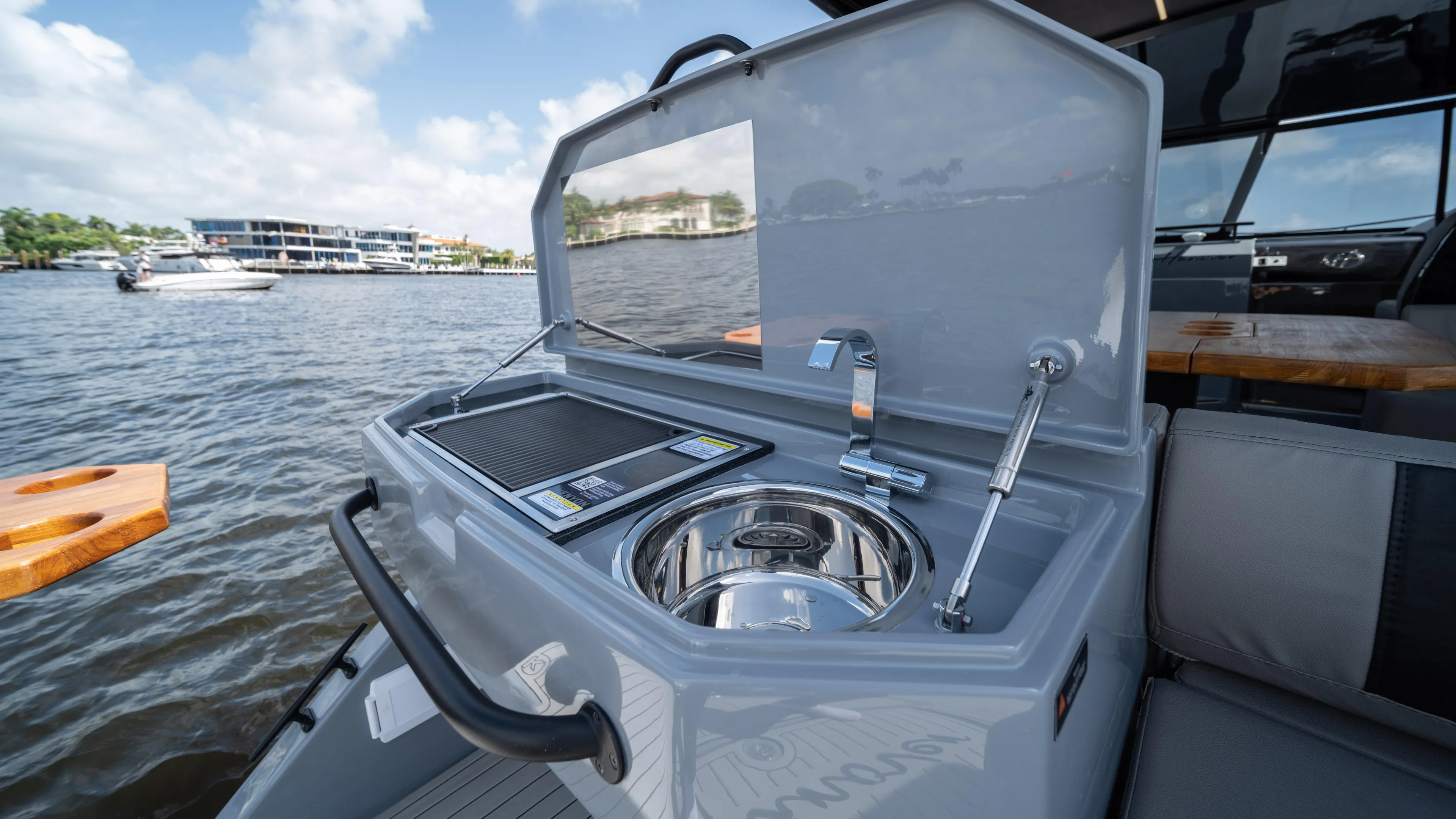 Custom Order Yours Today! Yacht Photos Pics 2025 Hanover 387 Outboard boat with onboard kitchenette and sink by the water.