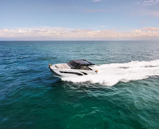 Custom Order Yours Today! Yacht Photos Pics 2025 Hanover 387 Outboard cruising on open ocean under clear skies.