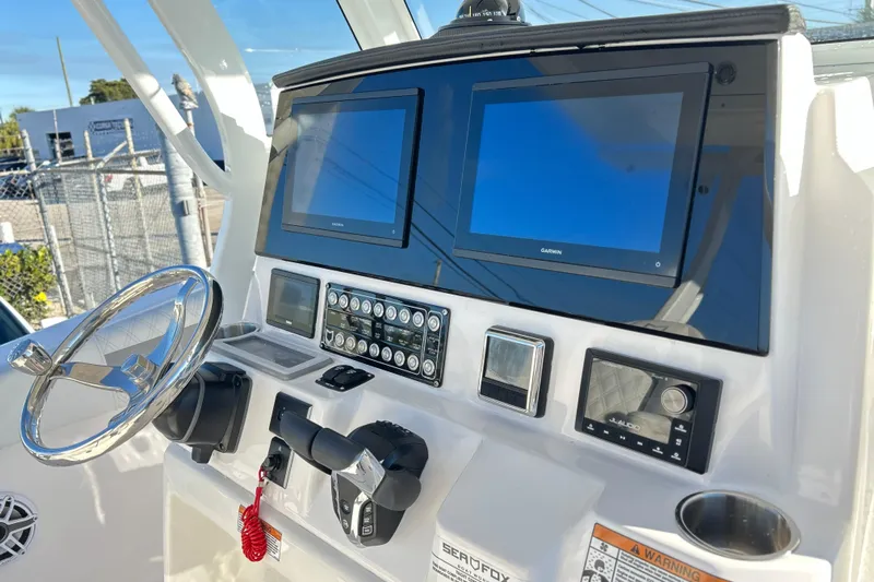 Yacht Photos Pics 2026 Sea Fox 288 Commander dashboard with dual Garmin displays and steering wheel.