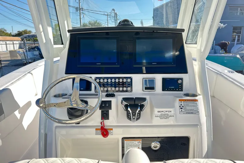  Yacht Photos Pics 2026 Sea Fox 288 Commander boat dashboard with dual screens and steering wheel.