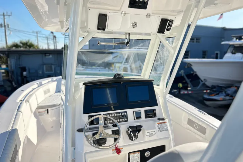  Yacht Photos Pics 2026 Sea Fox 288 Commander boat dashboard with dual screens and steering wheel.