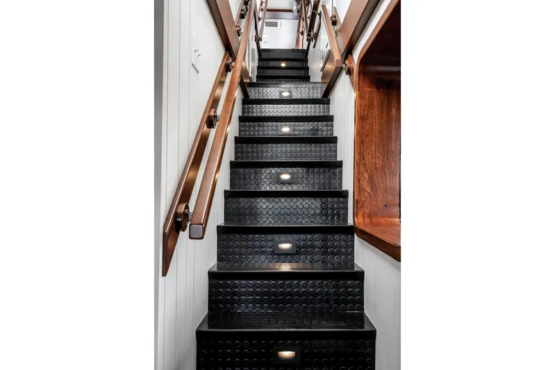 Anne S Pierce Yacht Photos Pics Staircase with black rubber steps and wooden handrails on an exploration ship, Glovertown Shipyard, 1982.