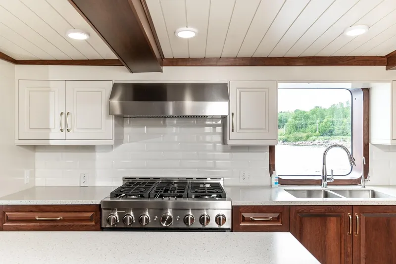 Anne S Pierce Yacht Photos Pics Modern ship kitchen with stainless steel appliances, white cabinets, and scenic window view. Glovertown Shipyard, 1982.