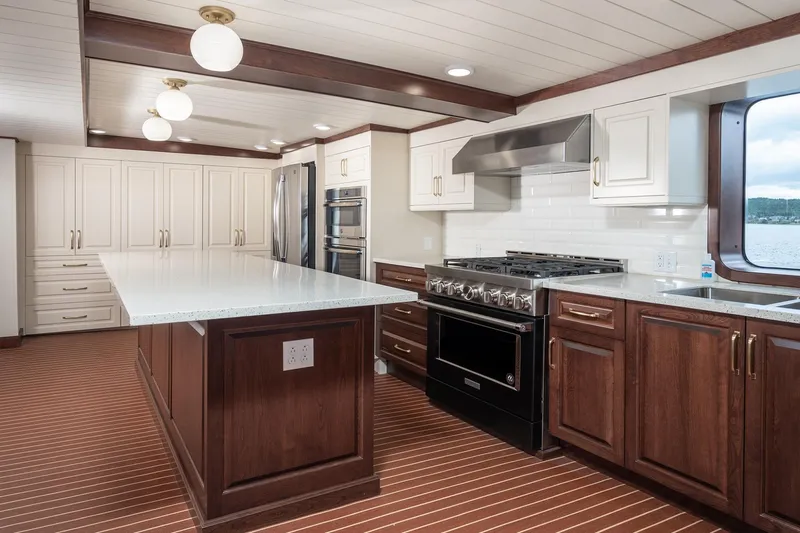 Anne S Pierce Yacht Photos Pics Luxurious ship kitchen with modern appliances, wooden cabinetry, and ocean view. Glovertown Shipyard, 1982 model.