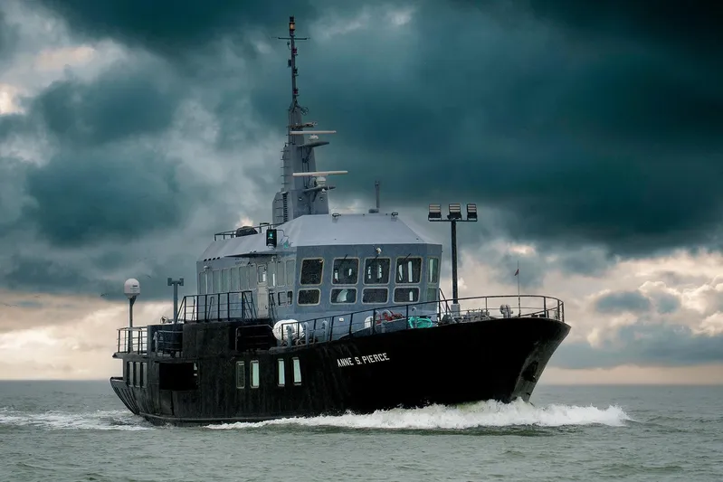 Anne S Pierce Yacht Photos Pics Exploration ship by Glovertown Shipyard (1982) navigating stormy seas under dramatic skies.
