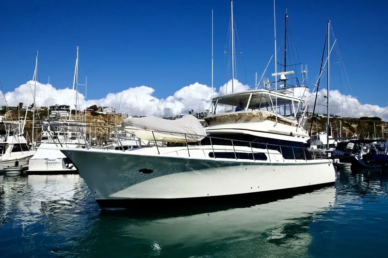The Donut Hull Yacht Photos Pics 2002 Mikelson 50 Sportfisher yacht docked in a marina under clear blue skies.