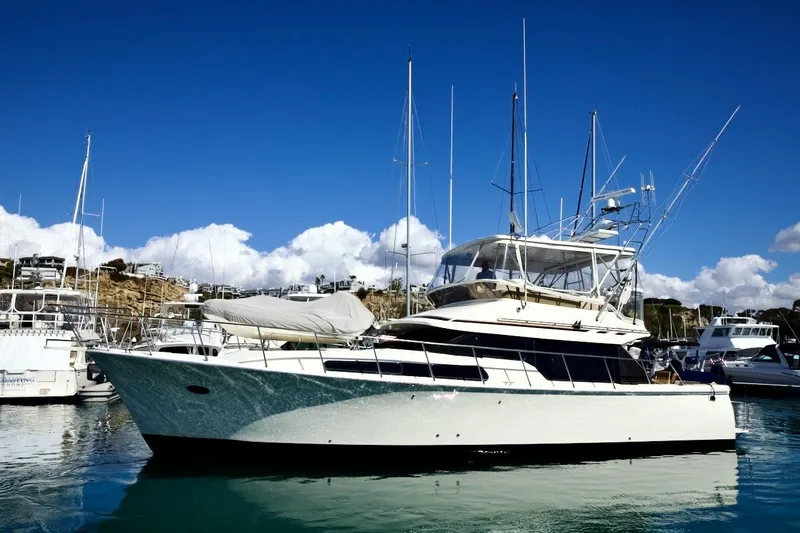 The Donut Hull Yacht Photos Pics 2002 Mikelson 50 Sportfisher yacht docked in a sunny marina.