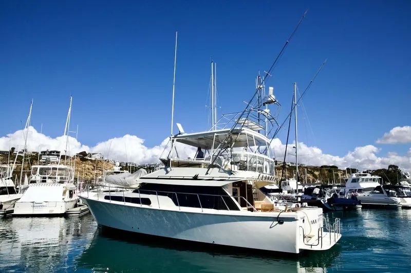 The Donut Hull Yacht Photos Pics 2002 Mikelson 50 Sportfisher yacht docked in a marina under clear blue skies.