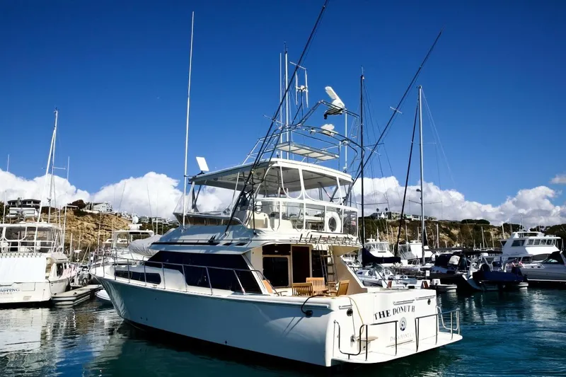 The Donut Hull Yacht Photos Pics 2002 Mikelson 50 Sportfisher yacht docked in a sunny marina.