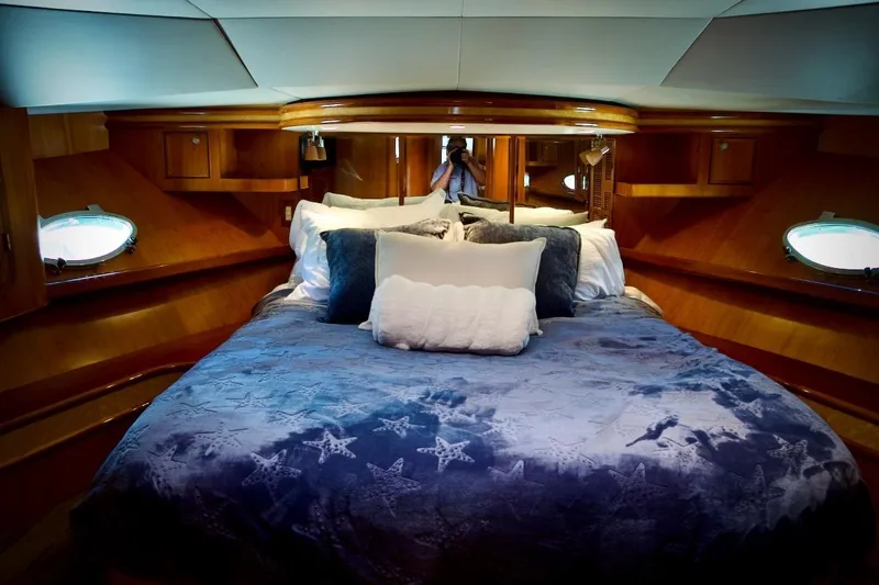 The Donut Hull Yacht Photos Pics Luxurious cabin interior of 2002 Mikelson 50 Sportfisher yacht with plush bedding.