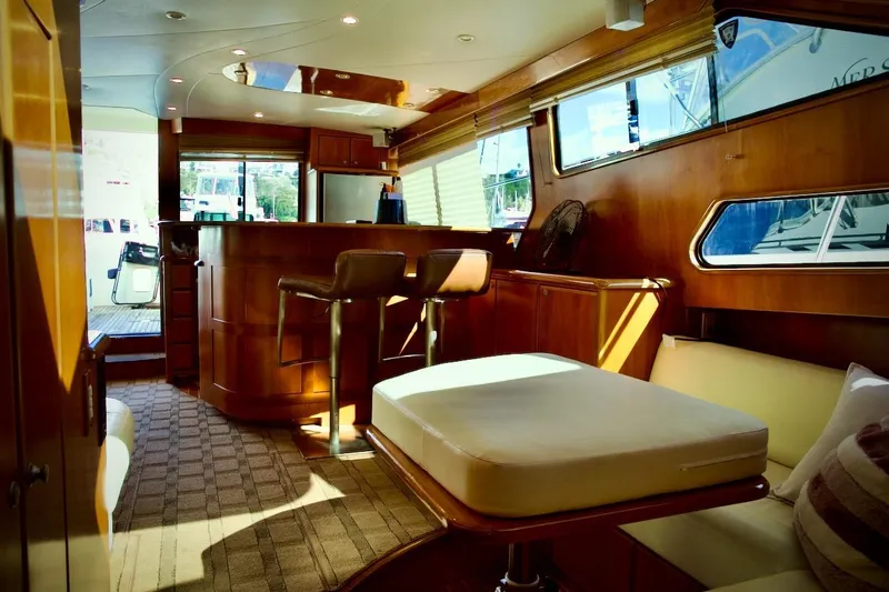 The Donut Hull Yacht Photos Pics Luxurious interior of 2002 Mikelson 50 Sportfisher yacht with elegant wood finishes.